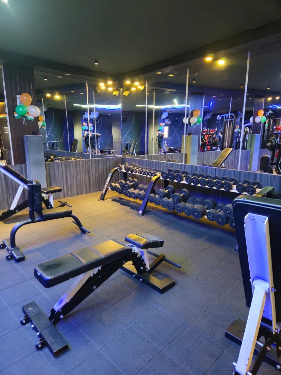 Dumbbell area with mirrored walls and benches
